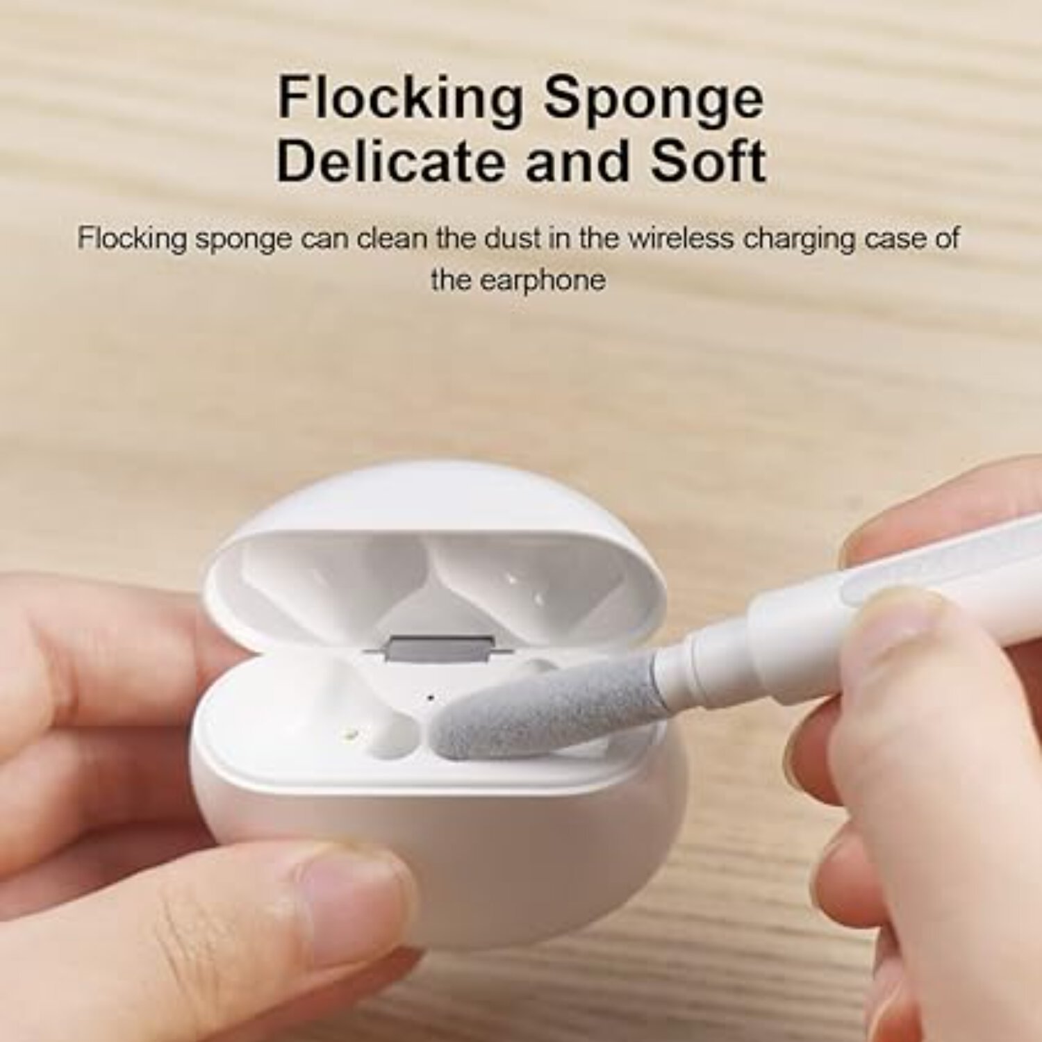 Cleaning pen with a flocking sponge cleaning the interior of a wireless charging case for AirPods, showcasing its delicate and soft design